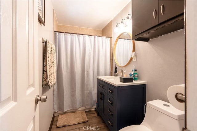 bathroom with walk in shower, toilet, vanity, and hardwood / wood-style flooring