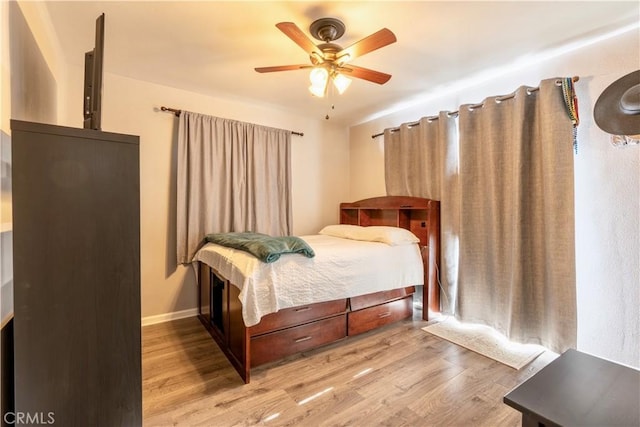 bedroom with ceiling fan and light hardwood / wood-style flooring