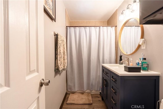 bathroom with shower / tub combo with curtain, vanity, and hardwood / wood-style flooring