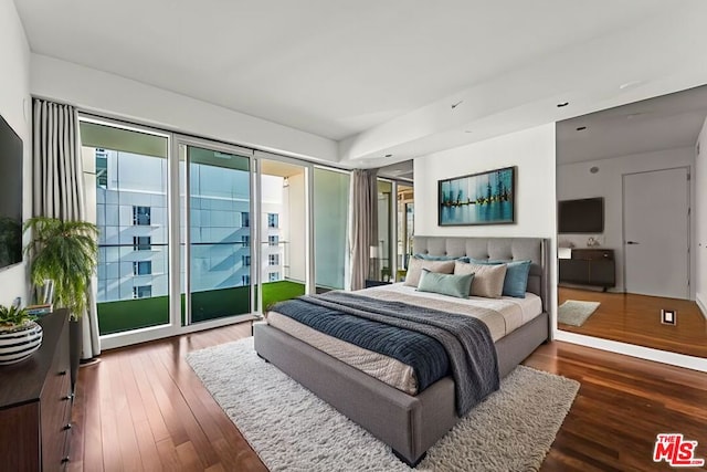 bedroom featuring dark hardwood / wood-style floors and access to outside