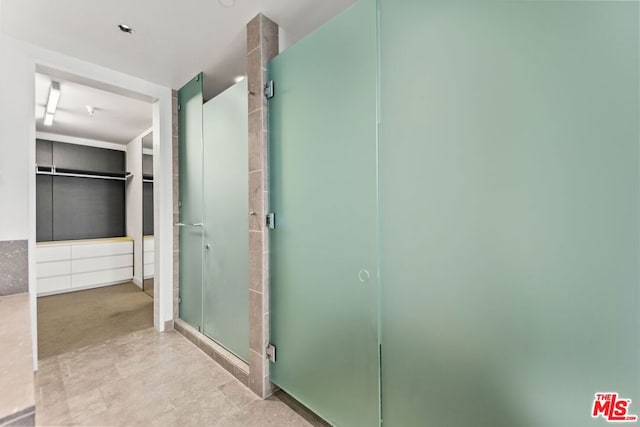 bathroom with a shower with shower door