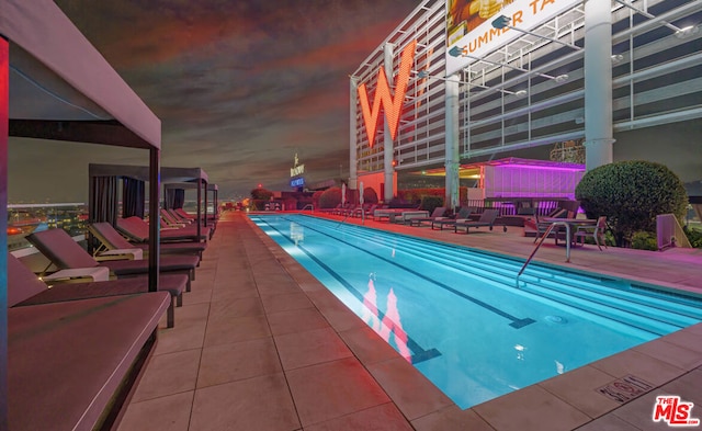 view of pool at dusk