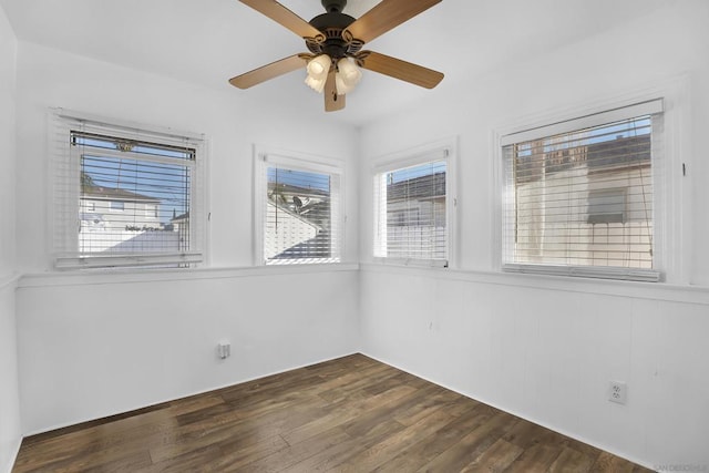 spare room featuring ceiling fan and dark hardwood / wood-style floors