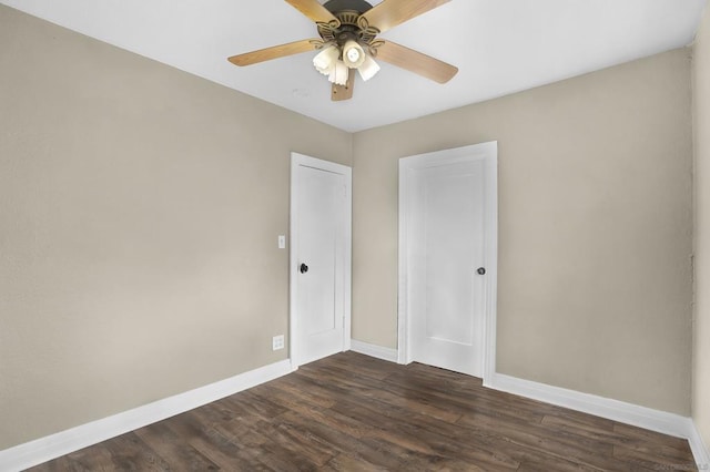 spare room with ceiling fan and dark hardwood / wood-style flooring