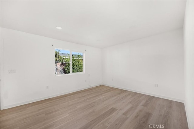 unfurnished room with light wood-type flooring