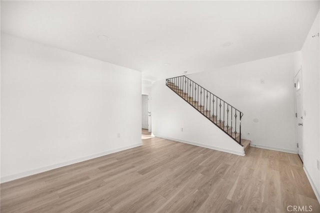 unfurnished living room with light hardwood / wood-style flooring