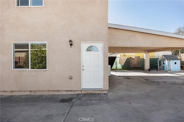 view of exterior entry with a carport