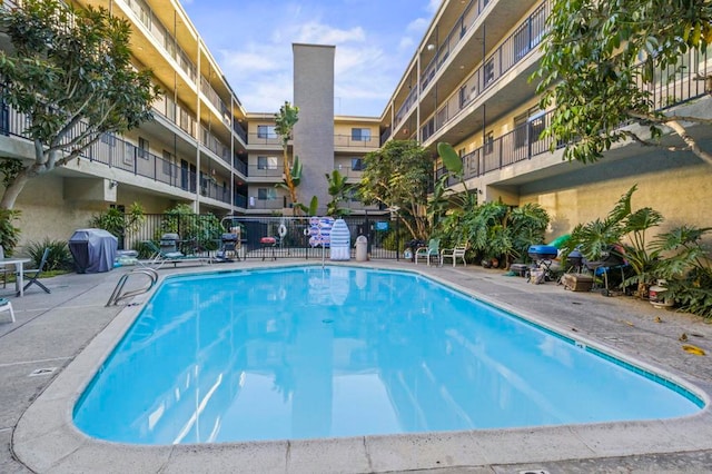 view of swimming pool with a grill and a patio