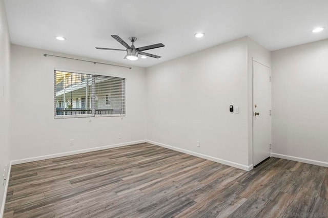 empty room featuring dark hardwood / wood-style floors and ceiling fan