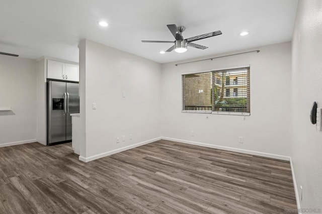 empty room featuring ceiling fan and dark hardwood / wood-style flooring