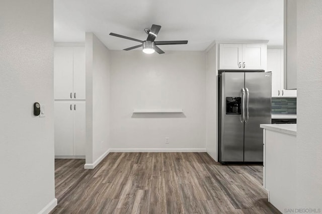 kitchen with ceiling fan, stainless steel fridge with ice dispenser, dark hardwood / wood-style flooring, backsplash, and white cabinets