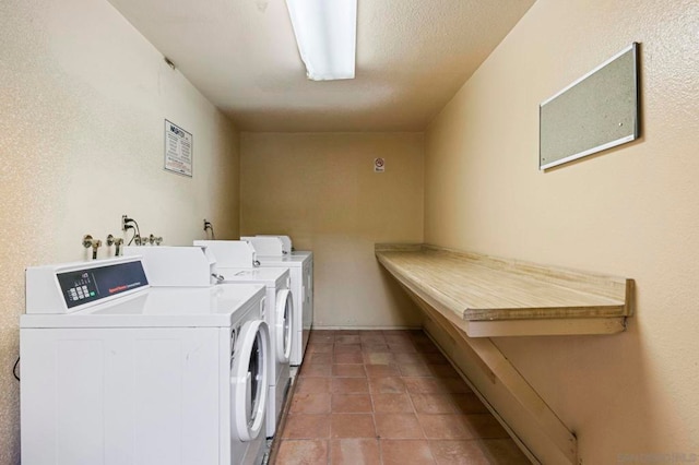 laundry area featuring separate washer and dryer and light tile patterned flooring