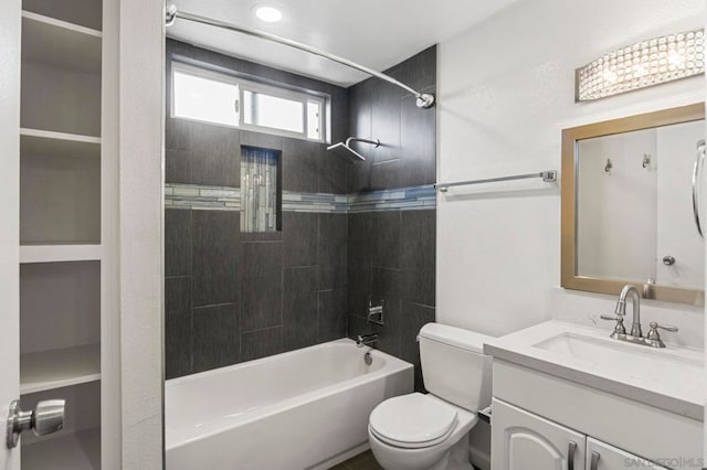 full bathroom featuring vanity, toilet, and tiled shower / bath