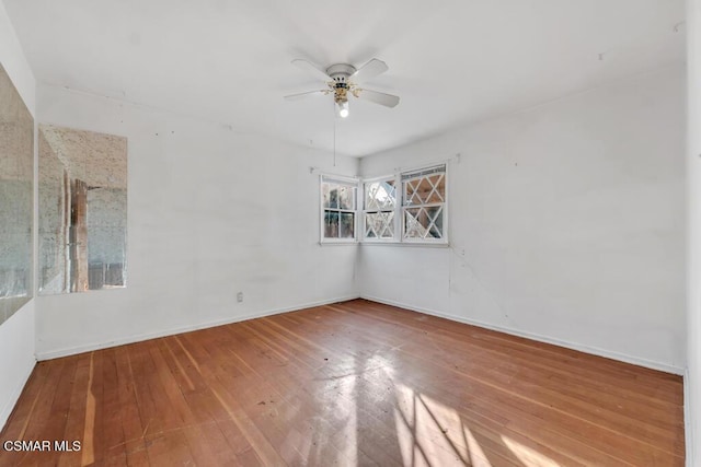 empty room with hardwood / wood-style flooring and ceiling fan