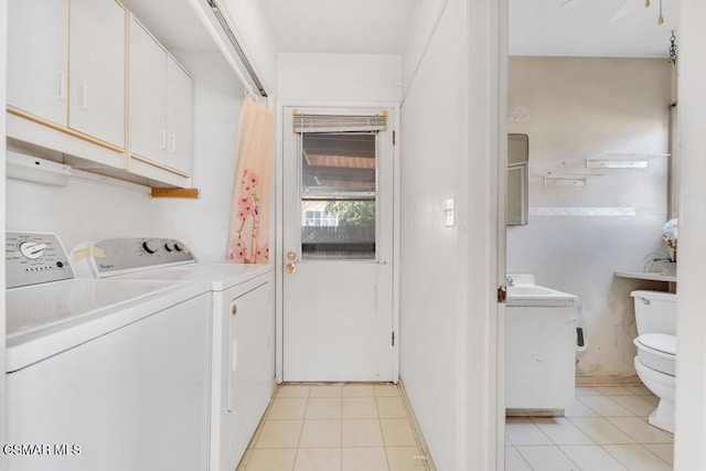 laundry room with washer and clothes dryer and light tile patterned floors