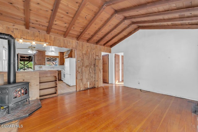 unfurnished living room with a wood stove, wooden ceiling, light hardwood / wood-style floors, and vaulted ceiling with beams