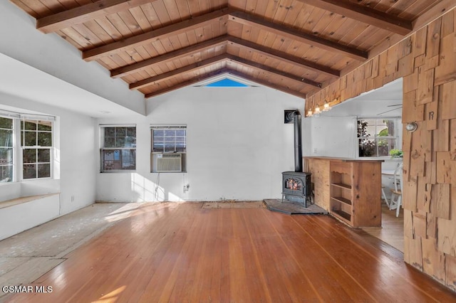 unfurnished living room with wood ceiling, a wood stove, lofted ceiling with beams, and hardwood / wood-style flooring