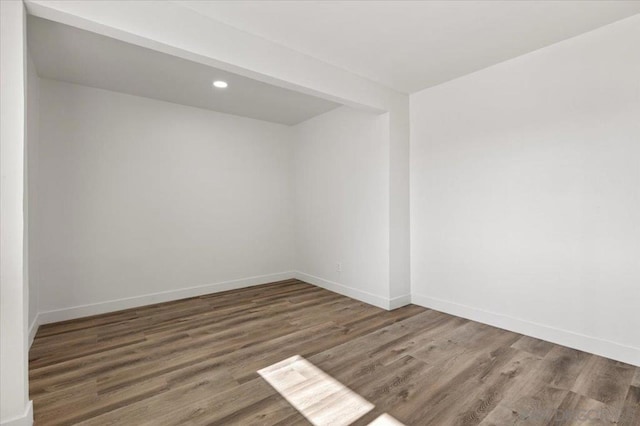 unfurnished room with dark wood-type flooring