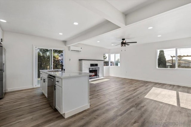 kitchen with a healthy amount of sunlight, white cabinets, and stainless steel appliances