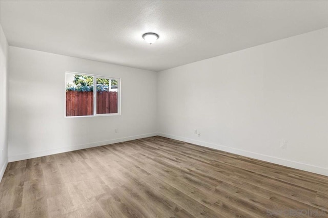 spare room featuring wood-type flooring