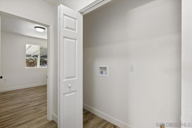 laundry room with washer hookup and hardwood / wood-style flooring