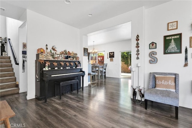 living area with an inviting chandelier and dark hardwood / wood-style flooring