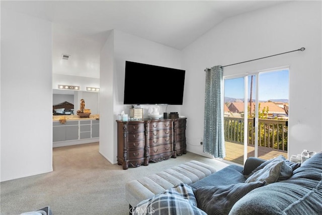 carpeted living room featuring vaulted ceiling