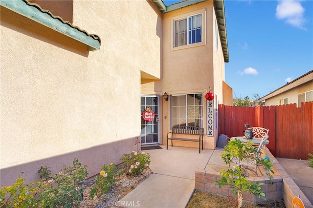 entrance to property featuring a patio