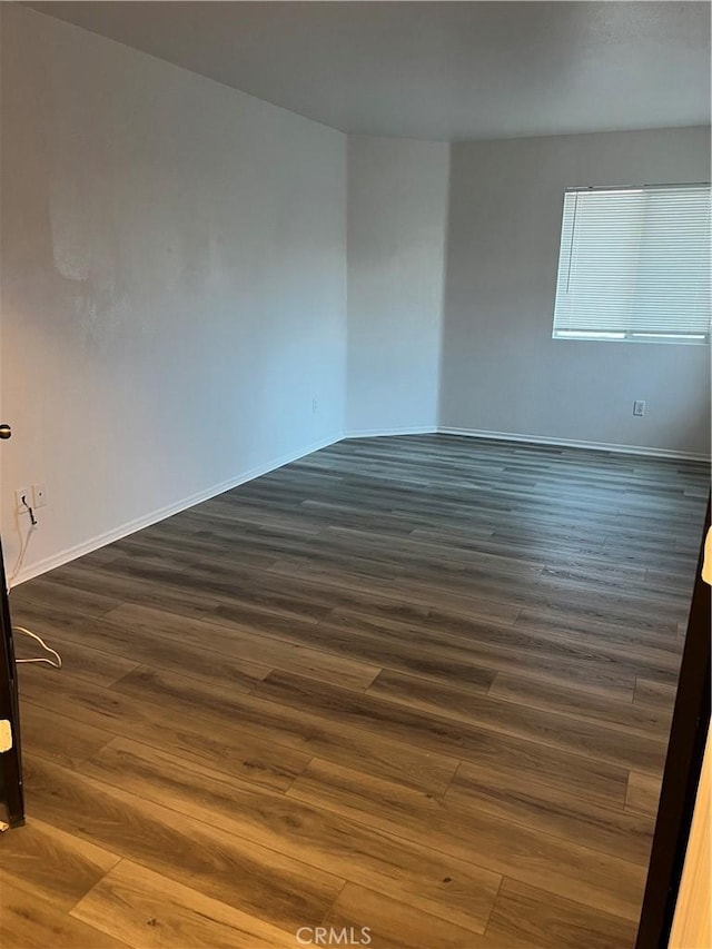 empty room featuring dark wood-type flooring