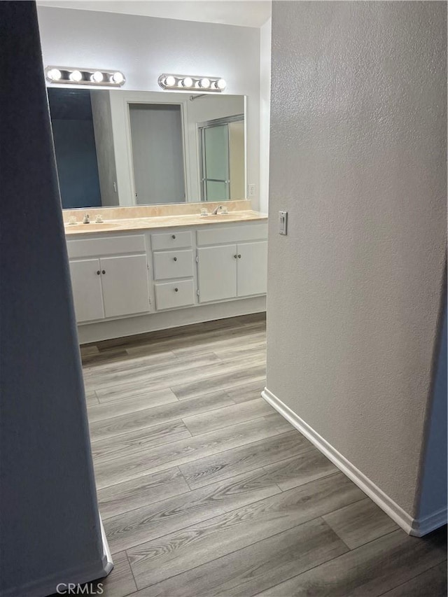 bathroom with hardwood / wood-style flooring and vanity