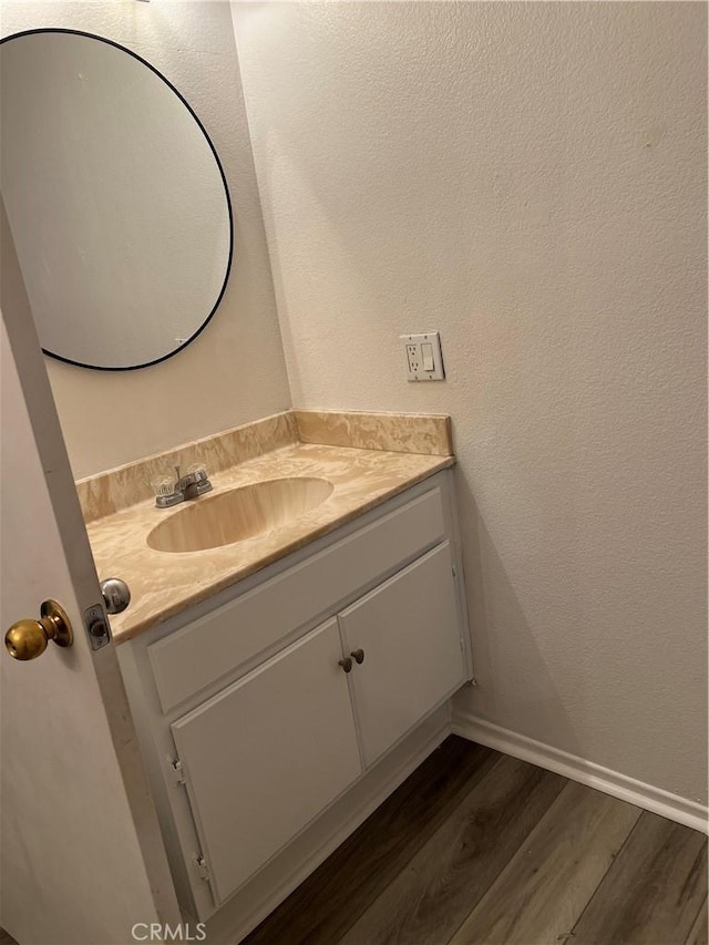 bathroom featuring hardwood / wood-style flooring and vanity