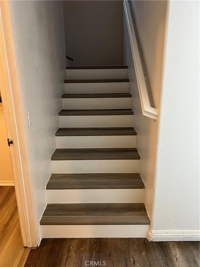 stairs with wood-type flooring