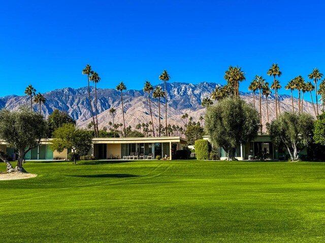 surrounding community featuring a mountain view and a yard