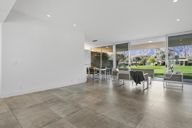 interior space with concrete flooring and a wall of windows