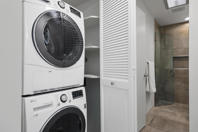 washroom with stacked washing maching and dryer