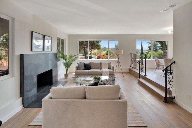 living room featuring light hardwood / wood-style floors and a fireplace