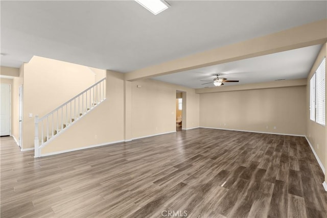 unfurnished living room with hardwood / wood-style floors and ceiling fan