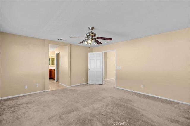 carpeted spare room featuring ceiling fan