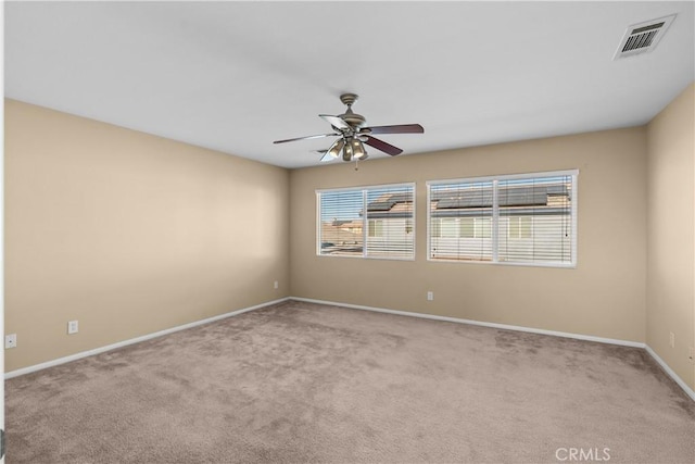 spare room featuring ceiling fan and light colored carpet