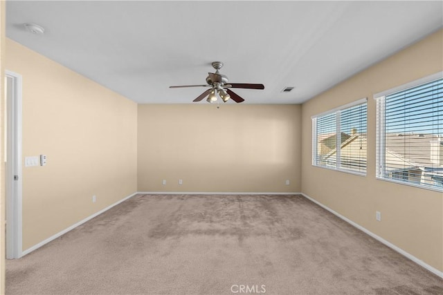 carpeted empty room featuring ceiling fan