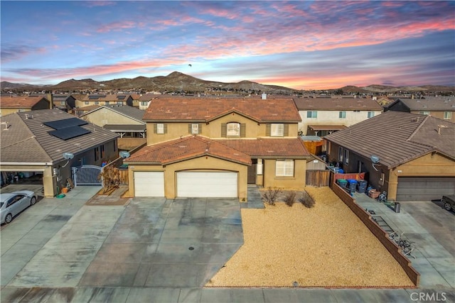 view of front facade featuring a mountain view and a garage