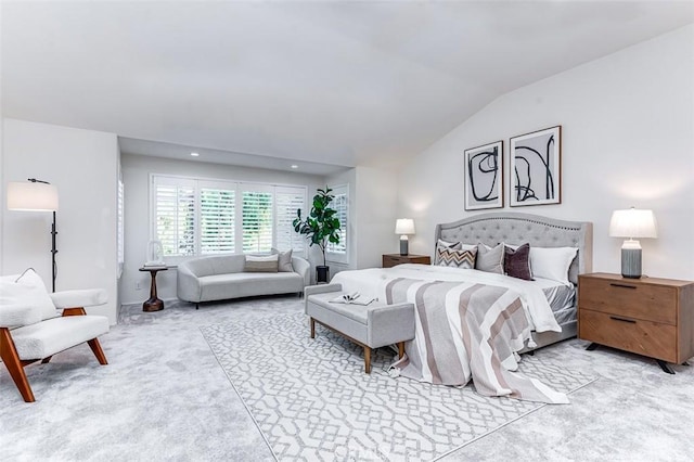 bedroom with light carpet and vaulted ceiling