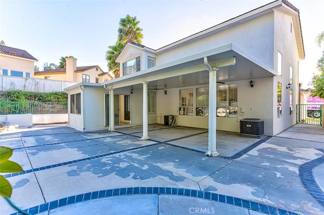 rear view of house with a patio and central AC unit