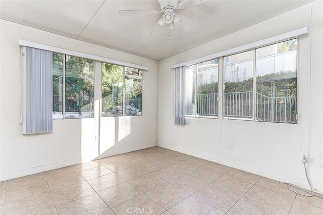 unfurnished room featuring ceiling fan and light tile patterned flooring