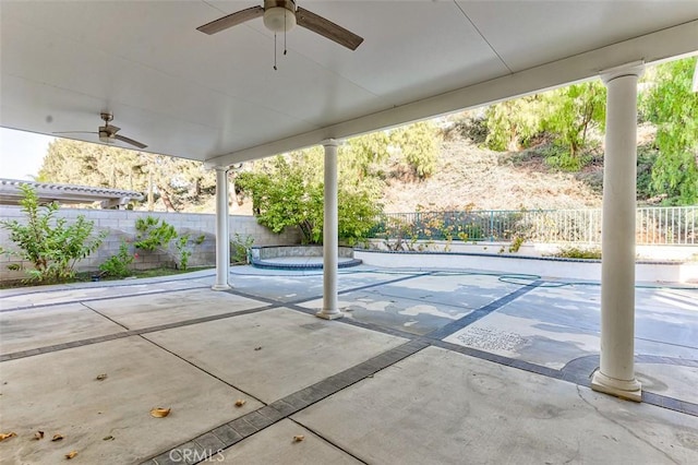 view of patio featuring ceiling fan and a swimming pool with hot tub