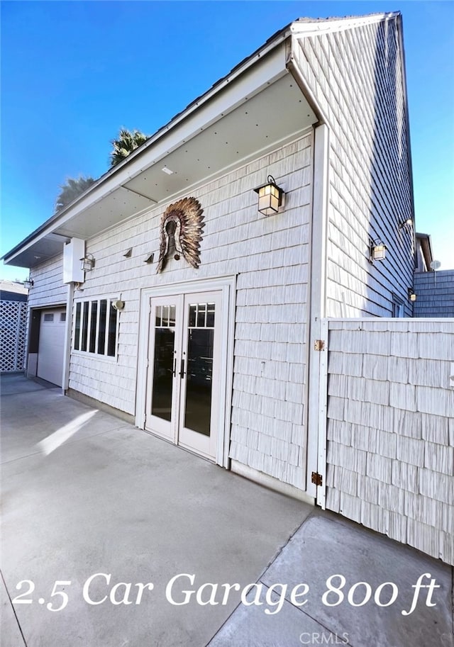 property entrance featuring a patio area and french doors