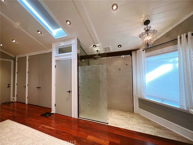 bathroom with hardwood / wood-style flooring, lofted ceiling, and crown molding