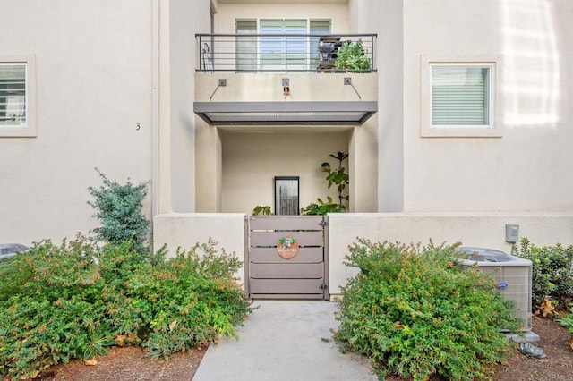 entrance to property with central air condition unit and a balcony