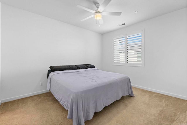 bedroom featuring light colored carpet and ceiling fan