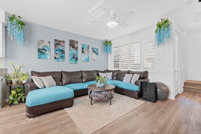 living room featuring light wood-type flooring and ceiling fan